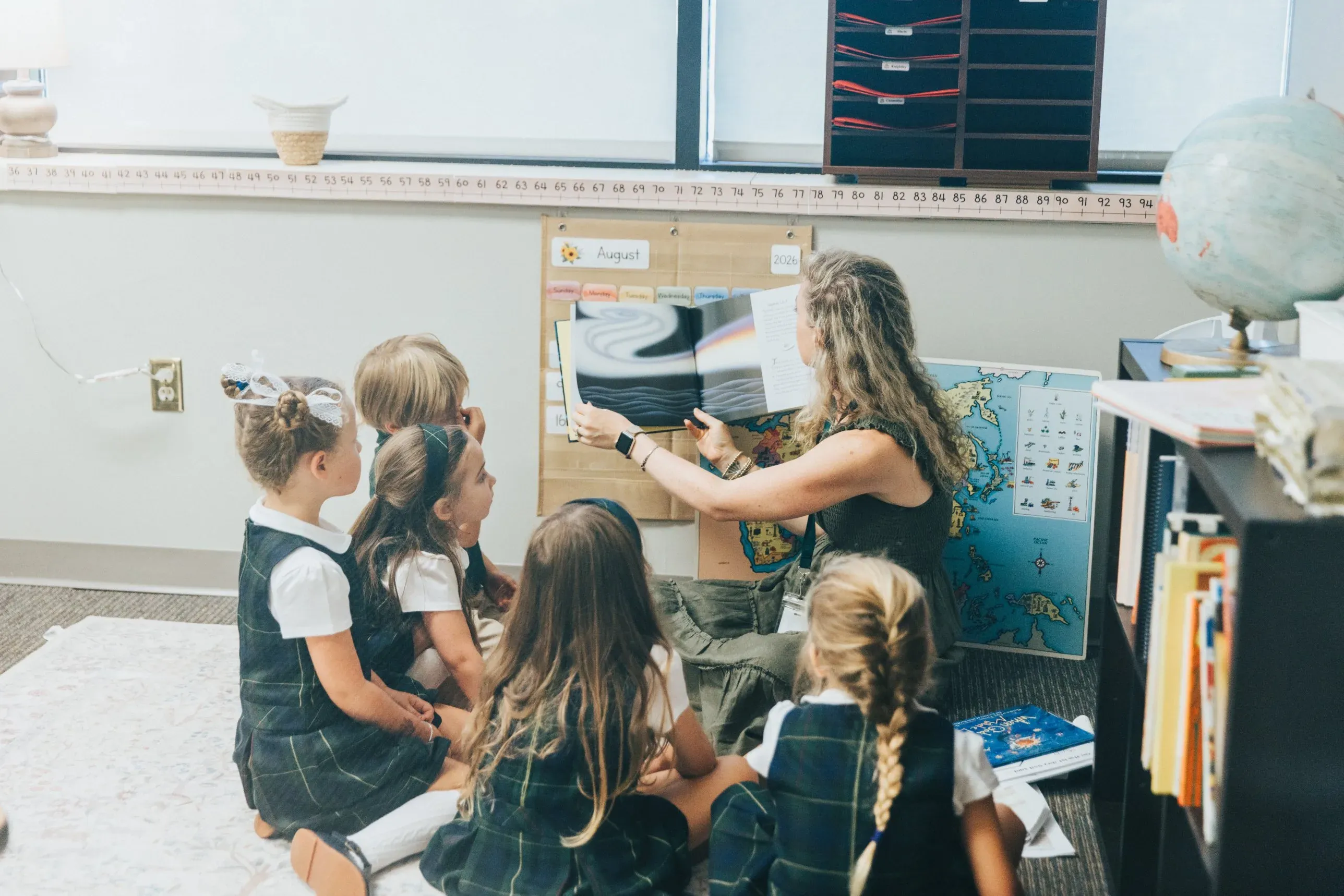 A teacher sharing a picture book with young students